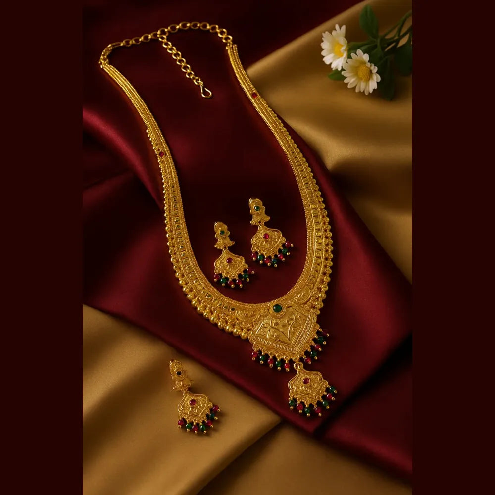 Model wearing OneGram gold long necklace beside jewellery dummy display, traditional South Indian temple jewellery for wedding and festive wear.