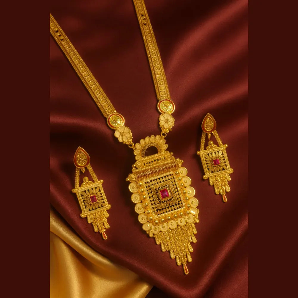 Two milligram gold plated Ranihaar necklace set with ruby stones placed on red and golden satin background, handcrafted RealGold finish jewellery.