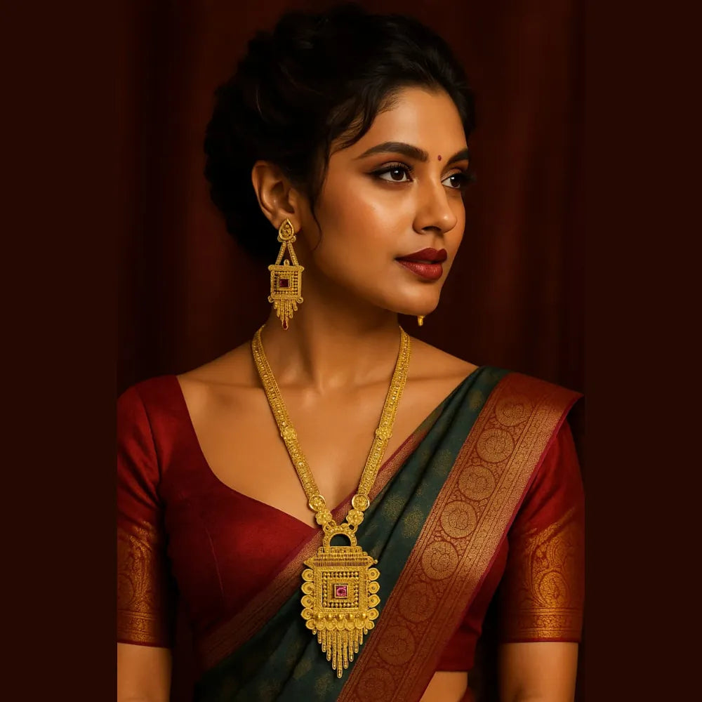 Woman wearing gold plated Ranihaar long necklace with red stone pendant and matching earrings, traditional Indian bridal jewellery look.