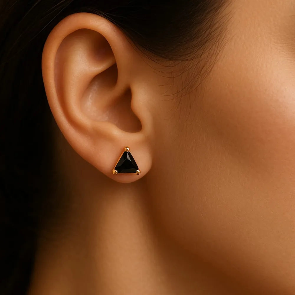 Unisex black crystal triangle ear studs with real gold plating, handcrafted with precision for a premium look. Elegant and lightweight, these daily wear earrings are made from copper and brass base with a pushback design. Ideal for men and women, these gold-plated black studs feature a glossy triangle crystal that adds a bold yet classy touch to any outfit. Perfect for gifting or personal use, from ZHome – Real, Good-Looking Jewellery.