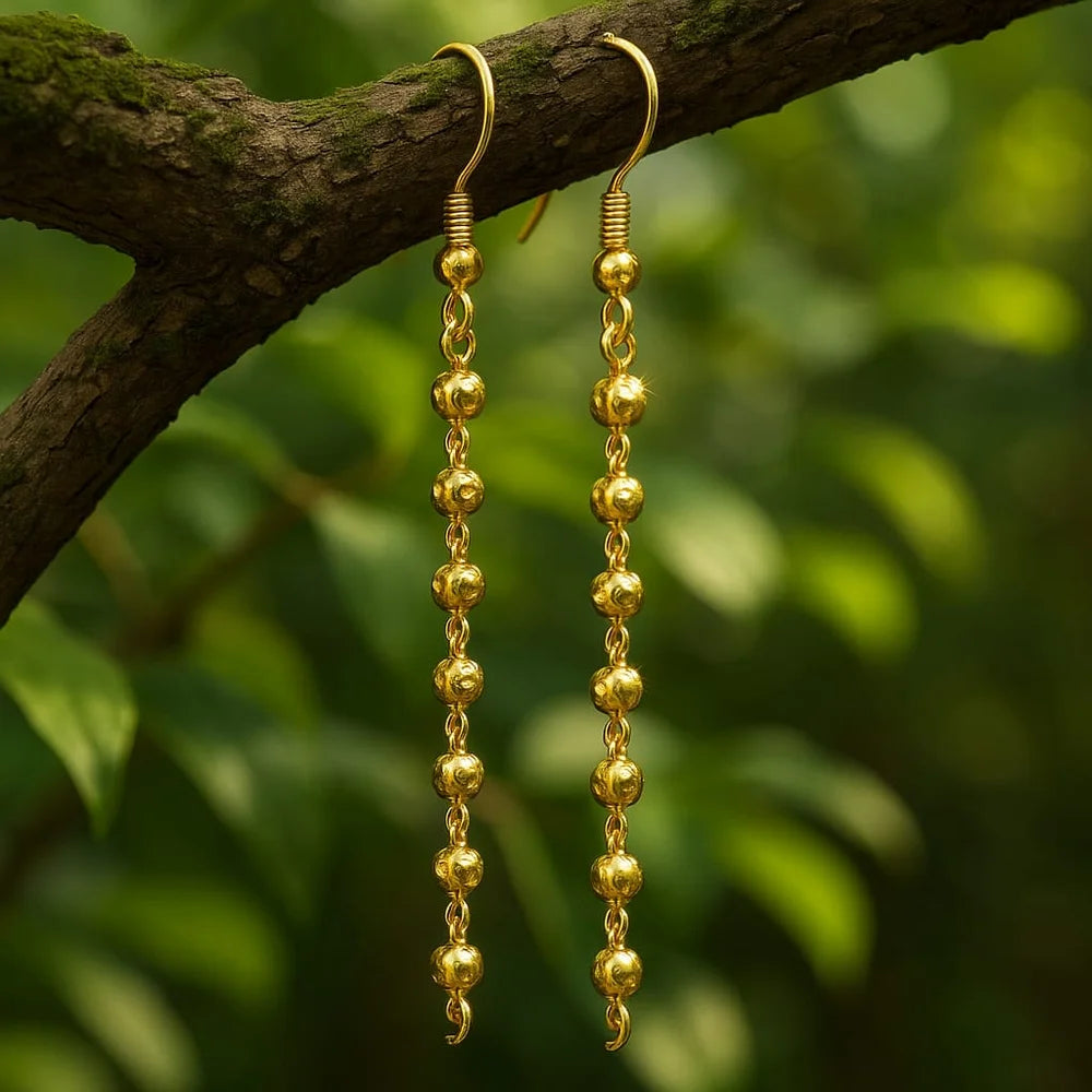 Close-up view of Zhome one gram gold long dangler earrings on ear – crafted by Sandeep Singh