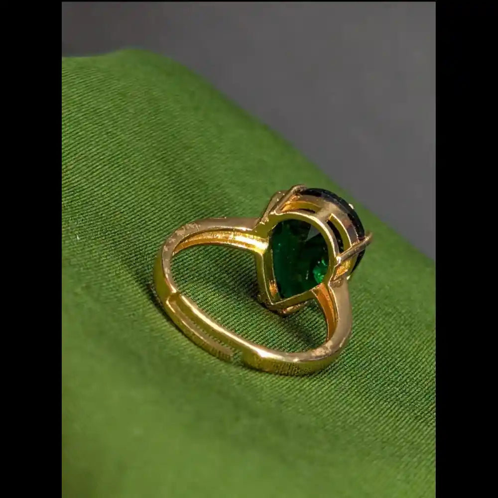 Gold-plated ring on green background